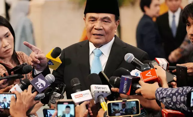 Indonesia's newly-appointed Coordinating Minister for Political and Security Affairs Djamari Chaniago talks to journalists after swearing-in ceremony at the presidential palace in Jakarta, Indonesia , Wednesday, Sept. 17, 2025. (AP Photo/Achmad Ibrahim)