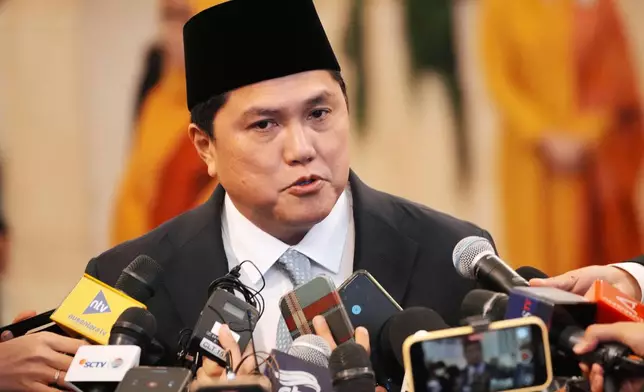 Indonesia's newly-appointed minister of youth and sports Erick Thohir talks to journalist after the swearing-in ceremony at the presidential palace in Jakarta, Indonesia, Wednesday, Sept. 17, 2025. (AP Photo/Achmad Ibrahim)