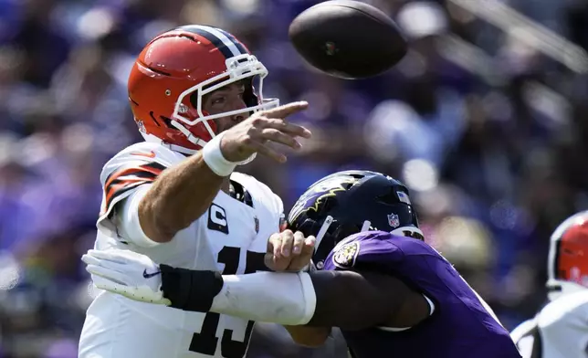 Cleveland Browns quarterback Joe Flacco throws under pressure from Baltimore Ravens linebacker Roquan Smith during the first half of an NFL football game, Sunday, Sept. 14, 2025, in Baltimore. (AP Photo/Stephanie Scarbrough)