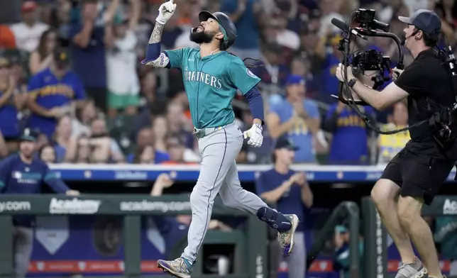 Seattle Mariners' J.P. Crawford reacts after hitting a grand slam against the Houston Astros during the second inning of a baseball game Sunday, Sept. 21, 2025, in Houston. (AP Photo/Eric Christian Smith)