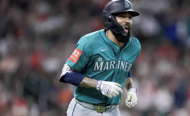 Seattle Mariners' J.P. Crawford rounds the bases after hitting a grand slam against the Houston Astros during the second inning of a baseball game Sunday, Sept. 21, 2025, in Houston. (AP Photo/Eric Christian Smith)