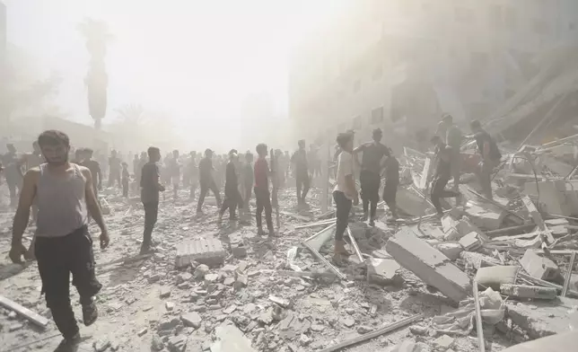 Palestinians inspect the rubble of a building after an Israeli military strike in Gaza City, Sunday, Sept. 14, 2025. (AP Photo/Yousef Al Zanoun)