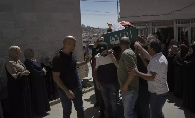 Mourners carry the body of Mohammad Alawi, 21, who according to Palestinian health officials died after being shot by settlers, during his funeral in the West Bank town of Deir Jarir, Sunday, Sept. 14, 2025. (AP Photo/Mahmoud Illean)