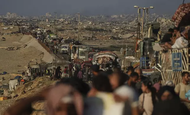 Displaced Palestinians flee northern Gaza by foot and in vehicles, carrying their belongings along the coastal road toward southern Gaza, Sunday, Sept. 14, 2025. (AP Photo/Abdel Kareem Hana)