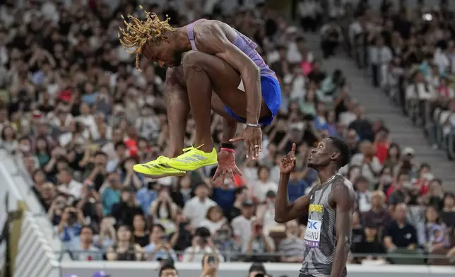 United States' Noah Lyles leaps ahead of his men's 200 meters semifinal at the World Athletics Championships in Tokyo, Thursday, Sept. 18, 2025. (AP Photo/Ashley Landis)