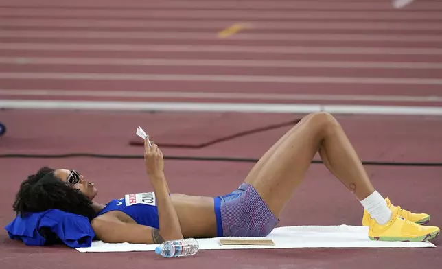 United States' Vashti Cunningham reads her notes while waiting her turn in the women's high jump qualification at the World Athletics Championships in Tokyo, Thursday, Sept. 18, 2025. (AP Photo/Matthias Schrader)