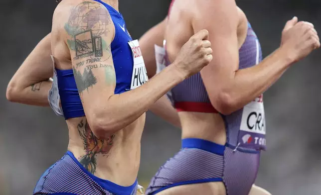 A view of the tattoo on the arm of United States' Shelby Houlihan as she races alongside United States' Elise Cranny in a women's 5,000 meters heat at the World Athletics Championships in Tokyo, Thursday, Sept. 18, 2025. (AP Photo/Petr David Josek)