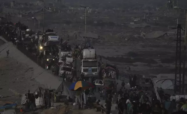 Displaced Palestinians flee Gaza City, by foot and vehicles, carrying their belongings along the coastal road in Nuseirat toward the southern Gaza Strip, Friday, Sept. 19, 2025. (AP Photo/Abdel Kareem Hana)