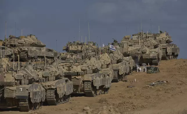 Israeli tanks at a staging area near the border with the Gaza Strip, in southern Israel, Sunday, Sept. 21, 2025. (AP Photo/Ohad Zwigenberg)