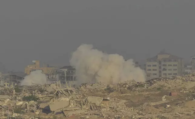 Smoke rises following an explosion in the Gaza Strip, as seen from southern Israel, Sunday, Sept. 21, 2025. (AP Photo/Ohad Zwigenberg)