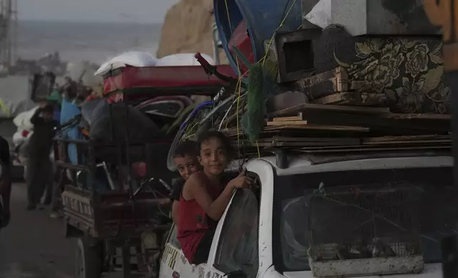 Displaced Palestinians flee Gaza City, carrying their belongings along the coastal road in Nuseirat toward the southern Gaza Strip, Friday, Sept. 19, 2025. (AP Photo/Abdel Kareem Hana)