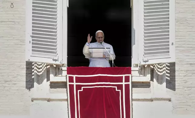 Pope Leo XIV delivers his speech as he recites the Angelus noon prayer from the window of his studio overlooking St.Peter's Square, at the Vatican, Sunday, Sept. 21, 2025. (AP Photo/Andrew Medichini)