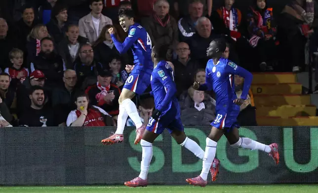 Chelsea's Facundo Buonanotte, left, celebrates scoring during the English League Cup third round soccer match between Lincoln City and Chelsea at the LNER Stadium, Lincoln, England, Tuesday Sept. 23, 2025. (Nigel French/PA via AP)