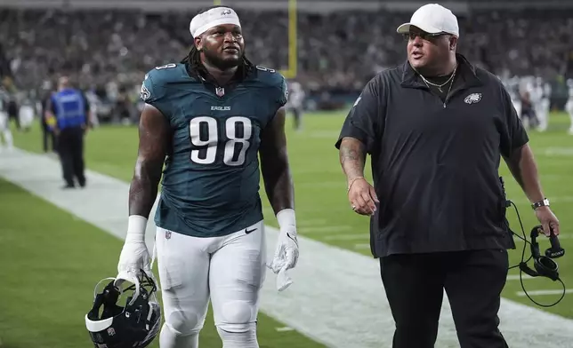 Philadelphia Eagles defensive tackle Jalen Carter (98) walks off the field after being disqualified for unsportsman like conduct before an NFL football game against the Dallas Cowboys Thursday, Sept. 4, 2025, in Philadelphia. (AP Photo/Matt Slocum)