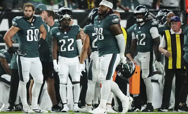 Philadelphia Eagles defensive tackle Jalen Carter (98) walks off the field after being disqualified for unsportsman like conduct before an NFL football game against the Dallas Cowboys Thursday, Sept. 4, 2025, in Philadelphia. (AP Photo/Matt Rourke)