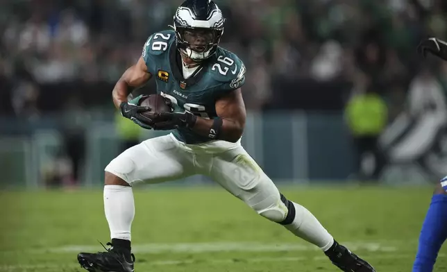 Philadelphia Eagles running back Saquon Barkley runs the ball against the Dallas Cowboys in the first half of an NFL football game Thursday, Sept. 4, 2025, in Philadelphia. (AP Photo/Matt Slocum)