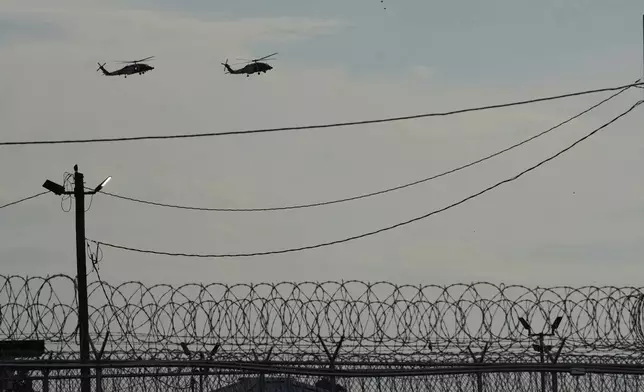 Helicopters in a flotilla transporting Homeland Security Secretary Kristi Noem land near "Camp 57," a facility to house immigration detainees at the Louisiana State Penitentiary in Angola, La., prior to her touring the facility with Louisiana Gov. Jeff Landry, Attorney General Pam Bondi, and ICE Deputy Director Madison Sheahan, Wednesday, Sept. 3, 2025. (AP Photo/Gerald Herbert)