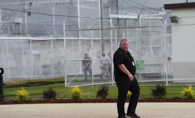 Security walk outside "Camp 57," a facility to house immigration detainees at the Louisiana State Penitentiary in Angola, La., prior to Homeland Security Secretary Kristi Noem touring the facility with Louisiana Gov. Jeff Landry, Attorney General Pam Bondi, and ICE Deputy Director Madison Sheahan, Wednesday, Sept. 3, 2025. (AP Photo/Gerald Herbert)
