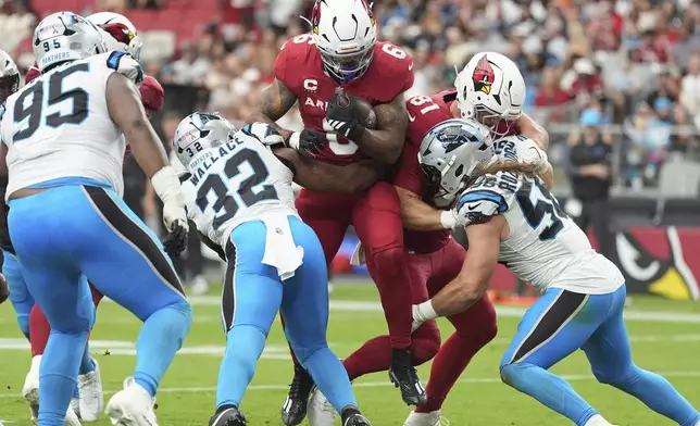 Arizona Cardinals running back James Conner (6) scores a touchdown as Carolina Panthers linebacker Trevin Wallace (32) defends during the second half of an NFL football game, Sunday, Sept. 14, 2025, in Glendale, Ariz. (AP Photo/Ross D. Franklin)
