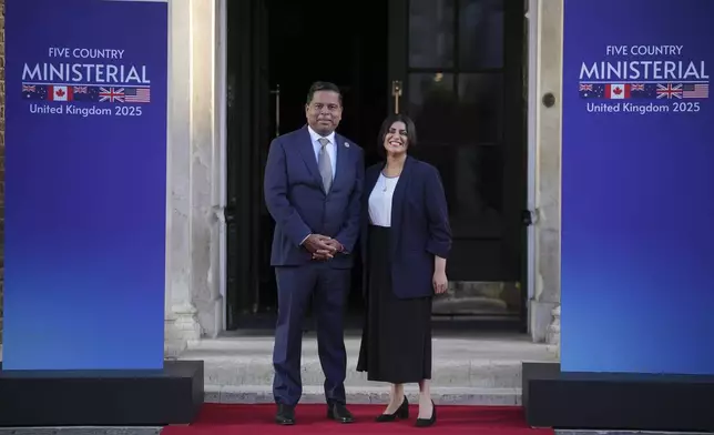 Britain's Home Secretary Shabana Mahmood, right, greets Canada Minister of Public Safety Gary Anandasangaree prior to the Five Country Ministerial meeting at the Honourable Artillery Company in London, Monday, Sept. 8, 2025 as interior ministers of the UK, US, Canada, Australia and New Zealand will discuss some of the major security threats facing our nations. (AP Photo/Kin Cheung)