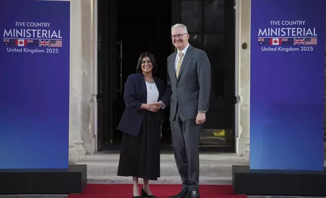 Britain's Home Secretary Shabana Mahmood, left, greets Australia Minister for Home Affairs Tony Burke prior to the Five Country Ministerial meeting at the Honourable Artillery Company in London, Monday, Sept. 8, 2025 as interior ministers of the UK, US, Canada, Australia and New Zealand will discuss some of the major security threats facing our nations. (AP Photo/Kin Cheung)