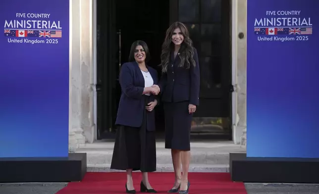 Britain's Home Secretary Shabana Mahmood, left, greets United States Homeland Security Secretary Kristi Noem prior to the Five Country Ministerial meeting at the Honourable Artillery Company in London, Monday, Sept. 8, 2025 as interior ministers of the UK, US, Canada, Australia and New Zealand will discuss some of the major security threats facing our nations. (AP Photo/Kin Cheung)
