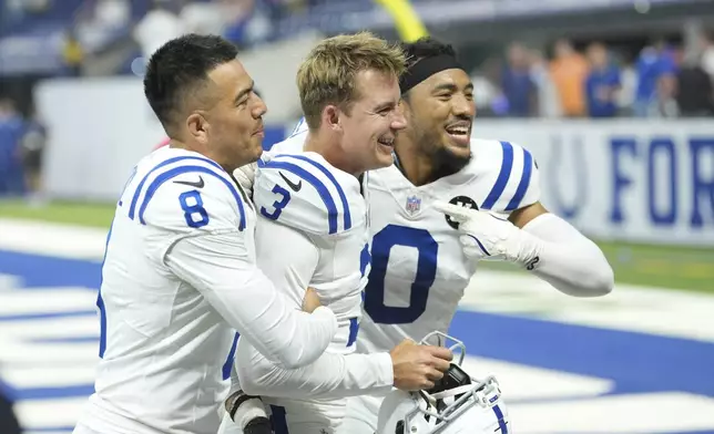 Indianapolis Colts place kicker Spencer Shrader (3) celebrates Sith Rigoberto Sanchez (8) and Cam Bynum (0) after Schrader kicked a game winning field goal during the second half an NFL football game against the Denver Broncos, Sunday, Sept. 14, 2025, in Indianapolis. (AP Photo/AJ Mast)