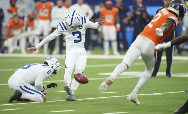 Indianapolis Colts place kicker Spencer Shrader (3) kicks the game winning field goal out of the hold of Rigoberto Sanchez during the second half an NFL football game against the Denver Broncos, Sunday, Sept. 14, 2025, in Indianapolis. (AP Photo/AJ Mast)