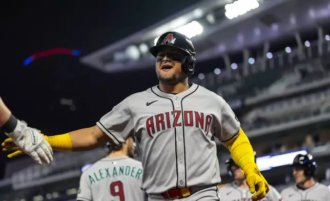 Arizona Diamondbacks' Gabriel Moreno (14) celebrates his three-run homer in the nineth inning of a baseball game against the Minnesota Twins, Friday, Sept. 12, 2025, in Minneapolis. (AP Photo/Mike Stewart)