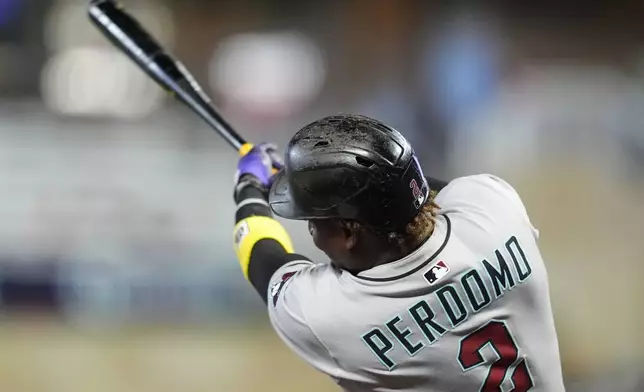 Arizona Diamondbacks shortstop Geraldo Perdomo (2) hits a two-run home run against the Minnesota Twins in the seventh inning of a baseball game, Friday, Sept. 12, 2025, in Minneapolis. (AP Photo/Mike Stewart)