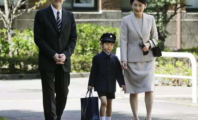 FILE - Japan's Prince Hisahito, center, accompanied by his parents Prince Akishino, left, and Princess Kiko, arrives at Ochanomizu University Elementary School for his entrance ceremony in Tokyo, Sunday, April 7, 2013. (AP Photo/Koji Sasahara, Pool, File)