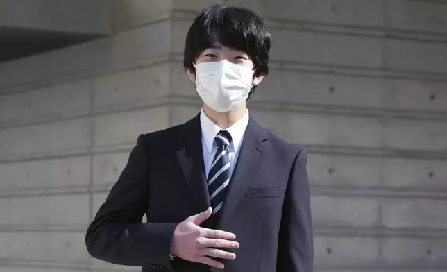 FILE- Japan's Prince Hisahito gestures as he poses for a photo before his entrance ceremony of Senior High School at Otsuka, the University of Tsukuba, Saturday, April 9, 2022, in Tokyo. (AP Photo/Eugene Hoshiko, Pool)
