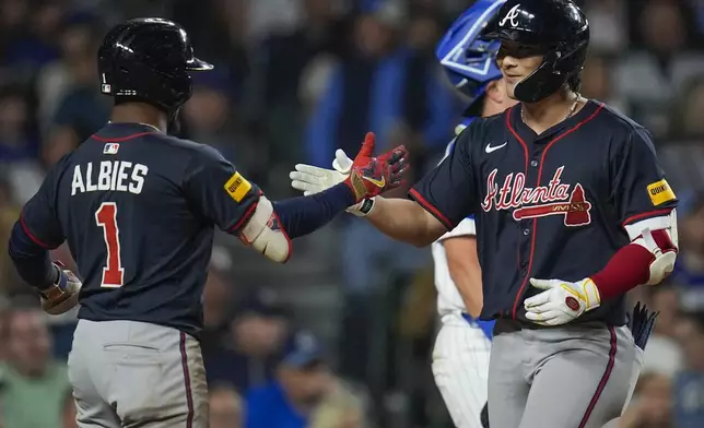 Atlanta Braves' Ha-Seong Kim, right, celebrates with Ozzie Albies after hitting a three-run home run during the seventh inning of a baseball game against the Chicago Cubs, Wednesday, Sept. 3, 2025, in Chicago. (AP Photo/Erin Hooley)