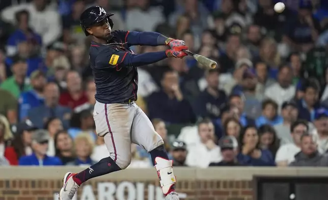 Atlanta Braves' Ozzie Albies hits a home run during the eighth inning of a baseball game against the Chicago Cubs, Wednesday, Sept. 3, 2025, in Chicago. (AP Photo/Erin Hooley)
