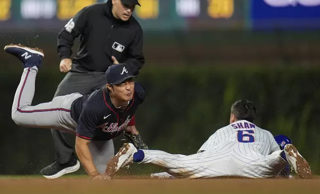 Chicago Cubs Matt Shaw (6) is caught stealing by Atlanta Braves shortstop Ha-Seong Kim during the fifth inning of a baseball game Wednesday, Sept. 3, 2025, in Chicago. (AP Photo/Erin Hooley)