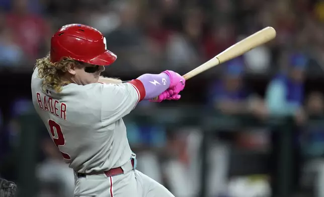 Philadelphia Phillies' Harrison Bader connects for a home run against the Arizona Diamondbacks during the fifth inning of a baseball game Friday, Sept. 19, 2025, in Phoenix. (AP Photo/Ross D. Franklin)