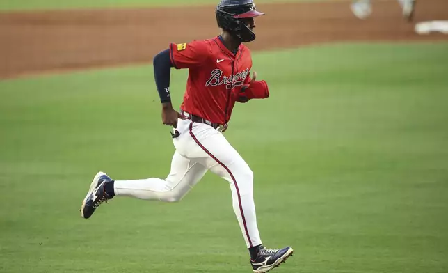 Atlanta Braves' Jurickson Profar runs to score in the first inning of a baseball game against the Seattle Mariners, Friday, Sept. 5, 2025, in Atlanta. (AP Photo/Colin Hubbard)