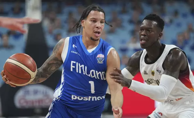 Finland's Miro Little, left, and Germany's Dennis Schroder in action during the Eurobasket, European Basketball Championship semi-final match between Germany and Finland at the Riga Arena in Riga, Latvia, Friday, Sept. 12, 2025. (AP Photo/Sergei Grits)