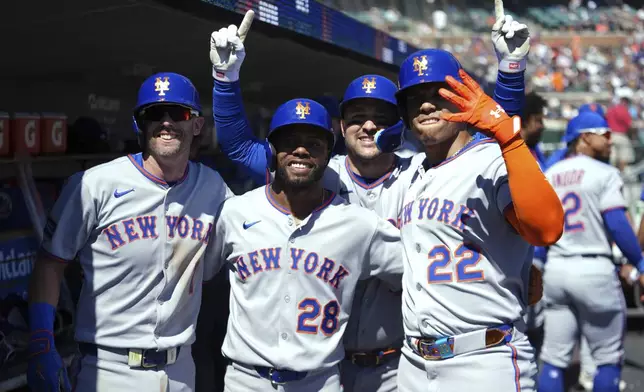 New York Mets' Juan Soto (22) celebrates his grand slam with Jeff McNeil (1), Cedric Mullins (28) and Luis Torrens (13) against the Detroit Tigers in the fourth inning during a baseball game Monday, Sept. 1, 2025, in Detroit. (AP Photo/Paul Sancya)