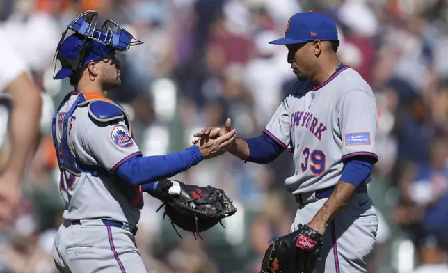 New York Mets catcher Luis Torrens, left, and pitcher Edwin DÌaz (39) celebrate after the final out against the Detroit Tigers in the ninth inning during a baseball game Monday, Sept. 1, 2025, in Detroit. (AP Photo/Paul Sancya)