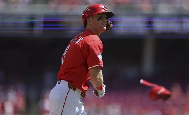 Cincinnati Reds' Matt McLain tosses his elbow guard after drawing a walk from St. Louis Cardinals pitcher Andre Pallante in the second inning of a baseball game, Sunday, Aug. 31, 2025, in Cincinnati. (AP Photo/Abdoul Sow)