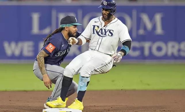 Tampa Bay Rays' Yandy Díaz, right, gets into second base ahead of the tag by Seattle Mariners shortstop J.P. Crawford with a double during the first inning of a baseball game Wednesday, Sept. 3, 2025, in Tampa, Fla. (AP Photo/Chris O'Meara)