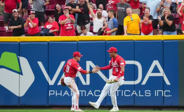 Cincinnati Reds outfielder Noelvi Marte (16) celebrates with teammate TJ Friedl (29) after catching a fly ball hit by Pittsburgh Pirates' Bryan Reynolds during the ninth inning of a baseball game, Thursday, Sept. 25, 2025, in Cincinnati. (AP Photo/Jeff Dean)