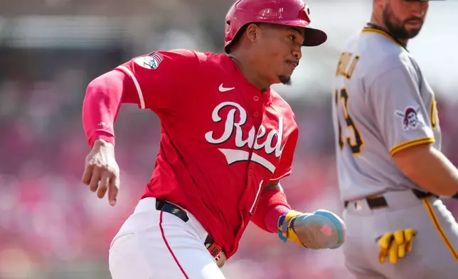 Pittsburgh Pirates third baseman Jared Triolo (19) looks on as Cincinnati Reds' Noelvi Marte rounds third base and scores on a single hit by Gavin Lux during the fifth inning of a baseball game, Thursday, Sept. 25, 2025, in Cincinnati. (AP Photo/Jeff Dean)