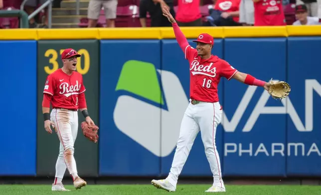 Cincinnati Reds outfielder Noelvi Marte (16) celebrates with teammate TJ Friedl (29) after catching a fly ball hit by Pittsburgh Pirates' Bryan Reynolds during the ninth inning of a baseball game, Thursday, Sept. 25, 2025, in Cincinnati. (AP Photo/Jeff Dean)