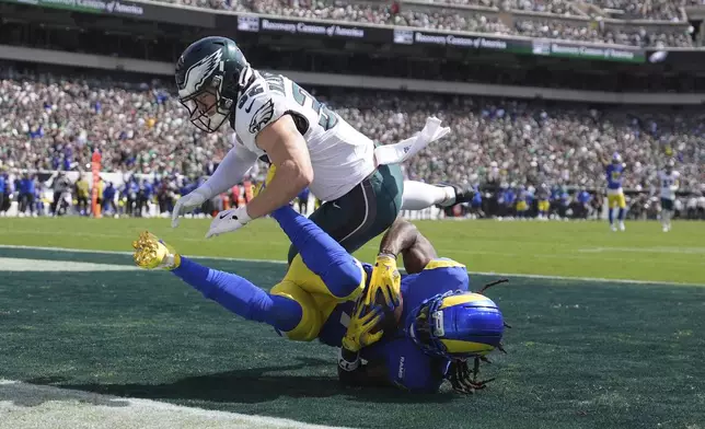 Los Angeles Rams wide receiver Davante Adams (17) catches a touchdown pass as Philadelphia Eagles safety Reed Blankenship (32) defends during the first half of an NFL football game Sunday, Sept. 21, 2025, in Philadelphia. (AP Photo/Matt Slocum)