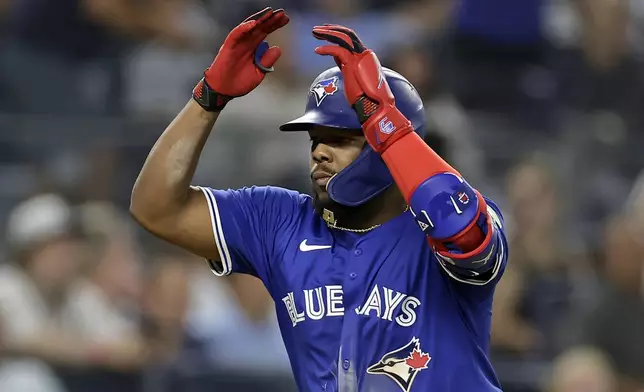 Toronto Blue Jays' Vladimir Guerrero Jr. reacts after hitting a home run during the fifth inning of a baseball game against the New York Yankees, Friday, Sept. 5, 2025, in New York. (AP Photo/Adam Hunger)