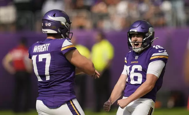 Minnesota Vikings kicker Will Reichard (16) celebrates a 62-yard field goal with Ryan Wright during the first half of an NFL football game against the Cincinnati Bengals, Sunday, Sept. 21, 2025, in Minneapolis. (AP Photo/Mike Stewart)