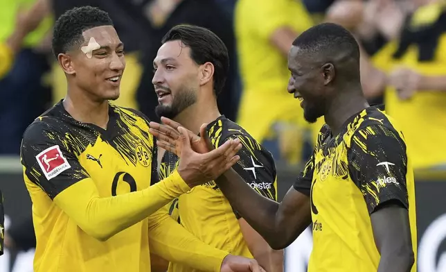 Dortmund's Serhou Guirassy, right, celebrates with Dortmund's Jobe Bellingham after scoring his side's second goal during the German Bundesliga soccer match between Borussia Dortmund and Union Berlin at the Signal-Iduna Park in Dortmund, Germany, Sunday, Aug. 31, 2025. (AP Photo/Martin Meissner)
