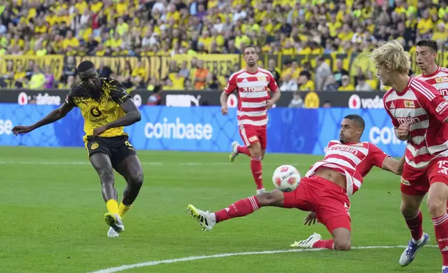 Dortmund's Serhou Guirassy, left, kicks the ball during the German Bundesliga soccer match between Borussia Dortmund and Union Berlin at the Signal-Iduna Park in Dortmund, Germany, Sunday, Aug. 31, 2025. (AP Photo/Martin Meissner)